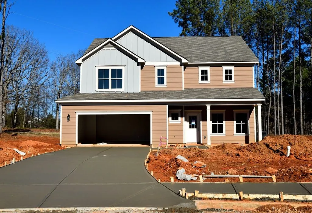 New two-story Austin home with a freshly finished concrete driveway
